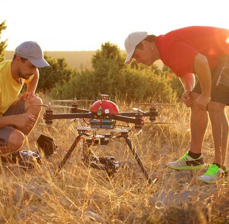 Two men prepare to fly a drone. Photo: iStockphoto
