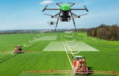 A drone communicates with a ground vehicle on a farm. Image: AgriTech Tomorrow.